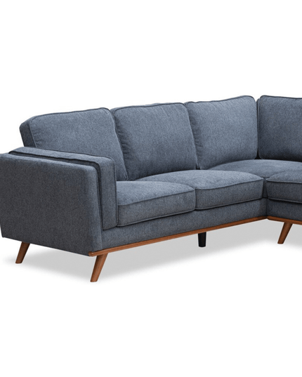 The Maddox LSF is a gray mid-century modern L-shaped sofa with tapered wooden legs and plush cushions, offering comfortable and stylish seating.