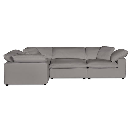 The Peyton 4 Piece Left L sectional sofa in gray includes three plush down and feather cushions. Its contemporary design features armrests and a left-facing chaise for ample seating. The sofa sits elegantly on short black legs, offering luxury and adaptability.