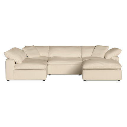 The Peyton 4 Piece + Ottoman in beige is an L-shaped sectional with plush cushions, low armrests, and a right-side chaise. Its small dark legs add versatility, ensuring a perfect blend of modern design and coziness for any living space.