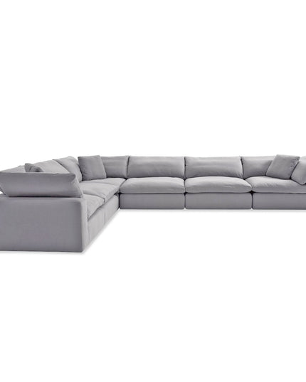 Experience modern comfort with this large, L-shaped sectional sofa. It features wide cushioned seats and backrests in light gray, complemented by plush upholstery. Dont forget to order your free fabric swatches!.