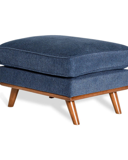 The Maddox Ottoman enhances any living space with its mid-century modern design, featuring a plush blue square cushion on four tapered wooden legs in a natural finish.