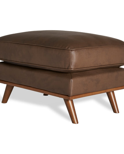 The Maddox Ottoman boasts a sleek brown leather finish, rectangular cushion top, and four tapered wooden legs. Its modern design complements both mid-century and contemporary interiors, fitting seamlessly into any living space.