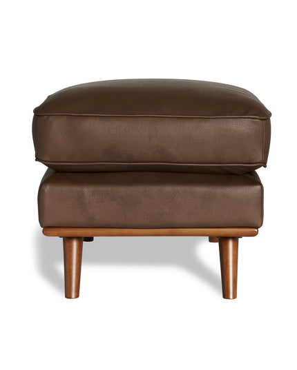 The Maddox Ottoman enhances your living space with its brown leather design, featuring two stacked cushions and four short wooden legs set against a crisp white background.