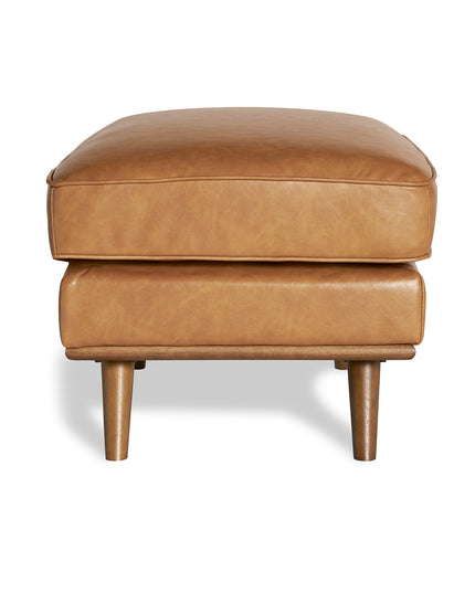 The Maddox Ottoman features a tan leather rectangular cushion and four wooden legs, adding mid-century charm to any living space, elegantly set against a plain white background.