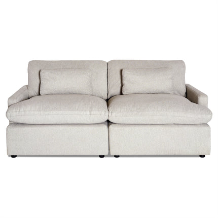 The My Cloud 2 Piece is a light beige, two-seater sofa featuring plush cushions and pillow-style armrests. It boasts a minimalist design with a slightly textured, machine-washable fabric and offers a sturdy, contemporary appearance.