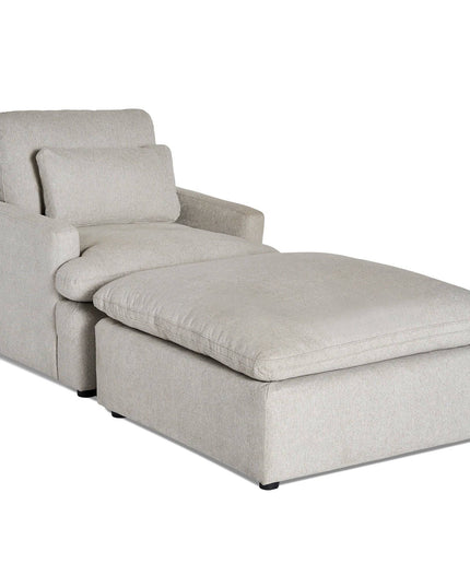 The My Cloud Chair is a light gray chaise lounge with a thick cushioned seat and backrest, including a plush pillow. This comfortable furniture piece features a modern, minimalist design supported by low black feet.