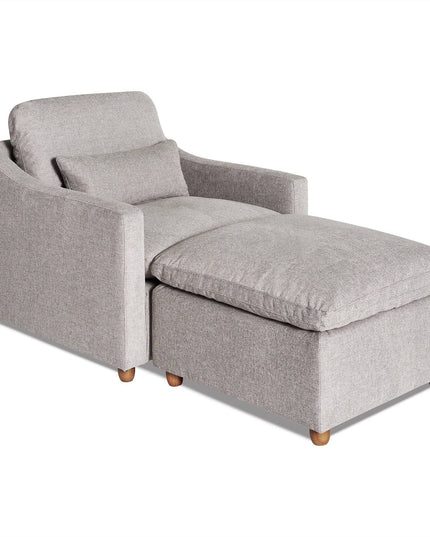 The My Cloud Slope Chair is a modern, gray fabric chaise lounge with a matching rectangular ottoman attached. Featuring a cushioned backrest, sleek arms, and wooden legs, it offers an inviting and cozy seating option for any living room.