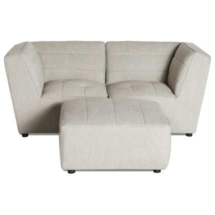 The Millenium 2 Piece + Ottoman is a light gray L-shaped modular sectional sofa with ultra-plush comfort, featuring two connected sections and cushioned seats. It has vertical stitching on the backrest and includes a matching rectangular ottoman. The floor is not visible.