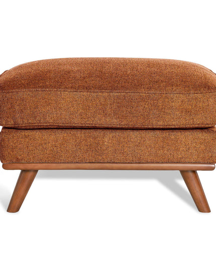 The Maddox Ottoman is a mid-century modern piece with an orange upholstered cushion and wooden legs. Its textured fabric enhances the elegant design, while slightly angled legs add to its retro aesthetic, making it ideal for any living space.