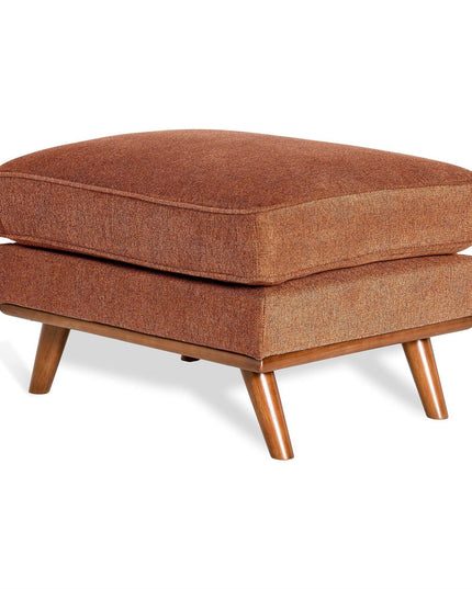 The Maddox Ottoman, with its mid-century modern design, features a rectangular shape, brown cushioned seat, and four angled wooden legs. Its textured fabric upholstery adds warmth and coziness, making it perfect for any living space.