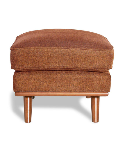 The Maddox Ottoman features brown upholstery and a rectangular cushion, gracefully sitting on wooden legs to bring mid-century charm and a soft shadow to your living space.