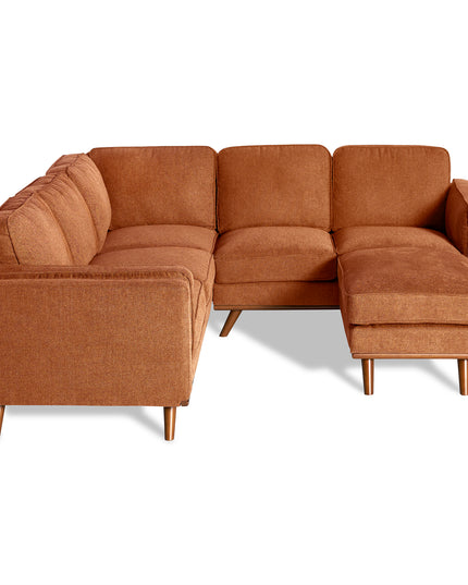 The Maddox is a brown L-shaped sectional with plush cushions and wooden legs, showcased against a white background. Its soft upholstery and cushioned seats and backrests offer a comfortable, inviting mid-century modern style.