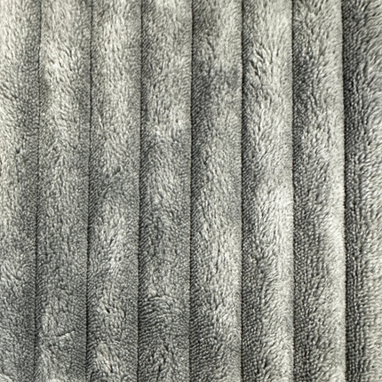 This close-up of gray, soft corduroy fabric shows vertical ridges creating a plush pattern with shadows and highlights. Its perfect for your Yeti 6 Piece Pit, known for its luxurious feel and customizable configurations.