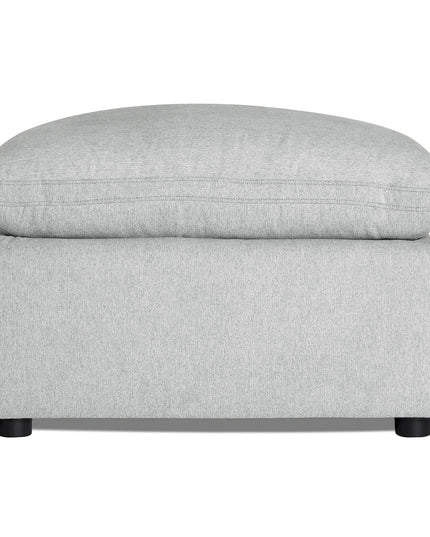 Discover the My Cloud 30 Ottoman, featuring light gray upholstery, a rectangular base, and cushioned top. It rests on four small round black legs, offering style and comfort for any space with customizable options.