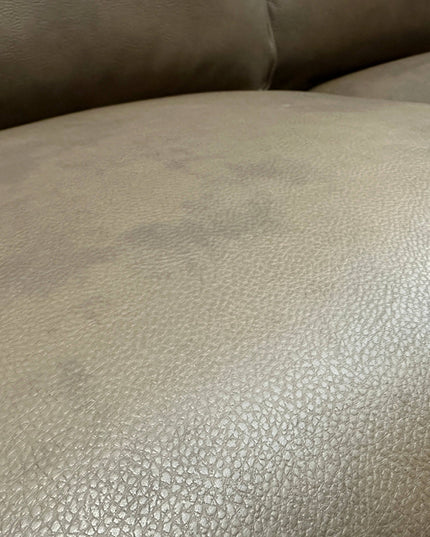 A close-up of the textured beige leather Maddox Sofa reveals a slightly wrinkled surface with subtle color variations. The soft material adds a cozy, lived-in feel, ideal for a mid-century modern living room blending everyday use with ultimate comfort.